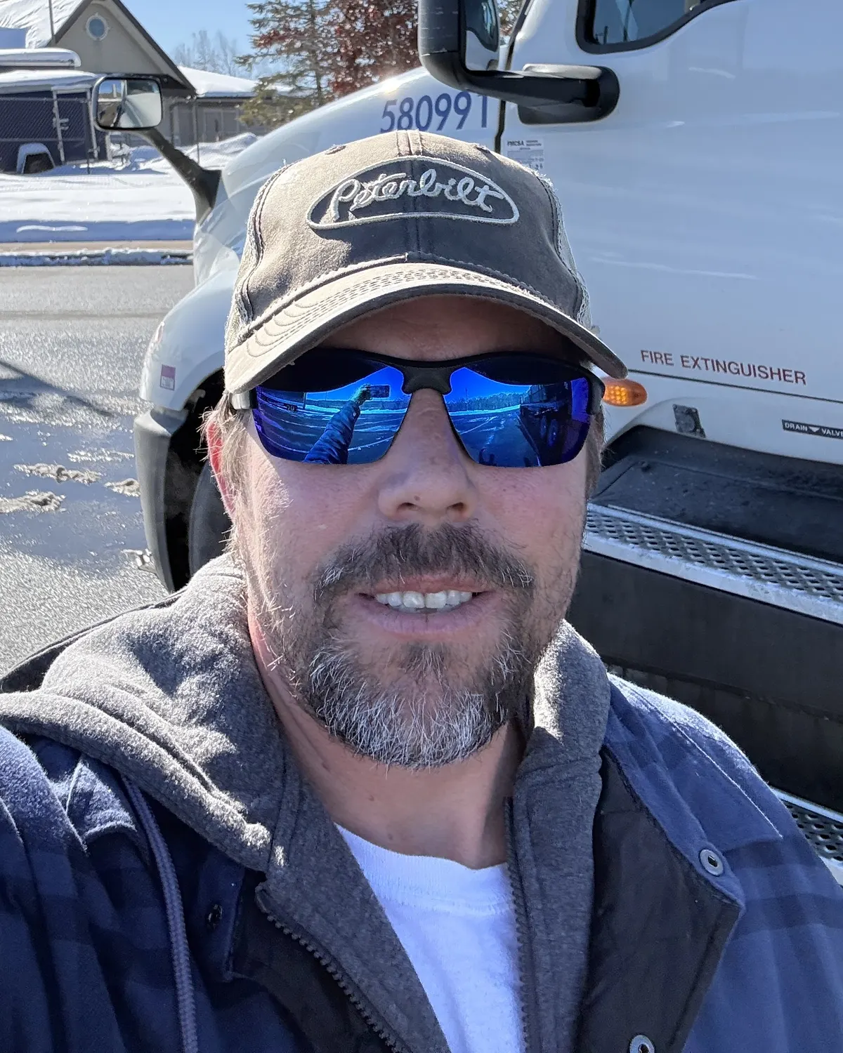 Jason Delgado, owner-operator of Delgado Trucking Services, beside unit 580991
